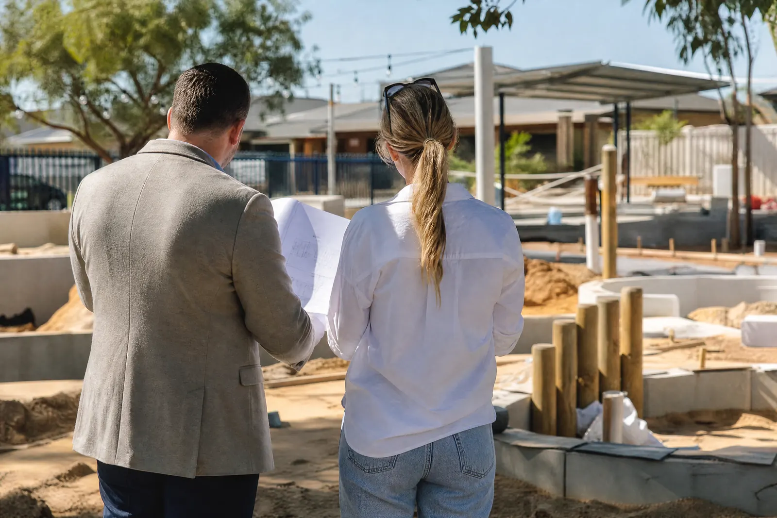 Investor and operator reviewing plans at a new early-learning centre under construction
